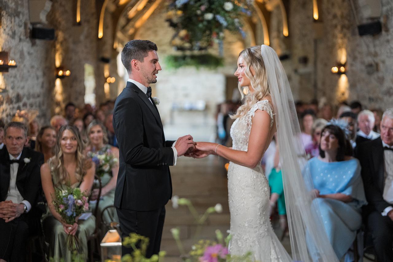 Couple holding hands at the end of the aisle about to get married