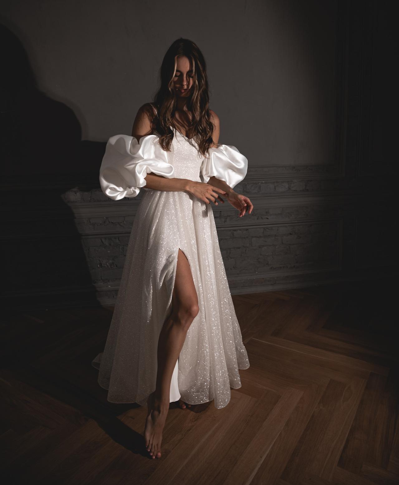 Model wearing a glittery puff sleeve wedding dress