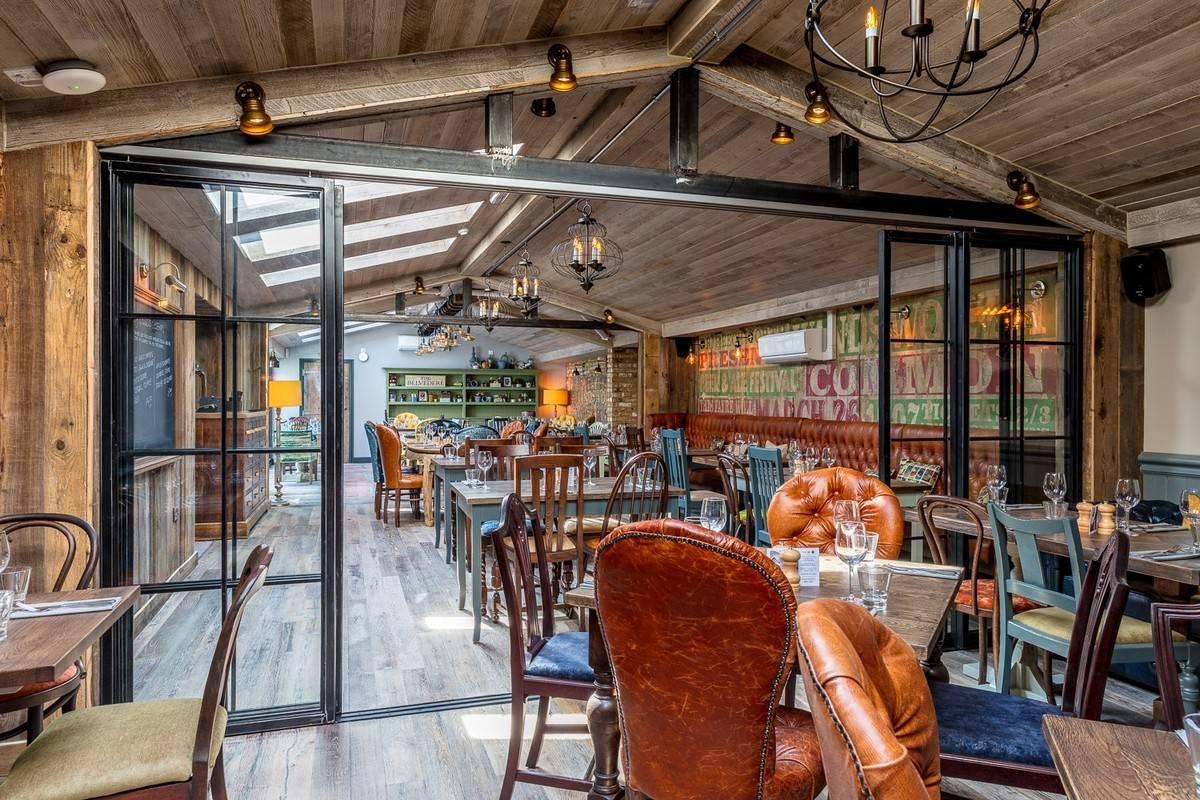 cosy pub dining room with wooden flooring and traditional leather seats