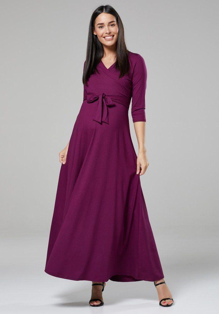 Pregnant model wearing a long sleeved purple wedding guest dress