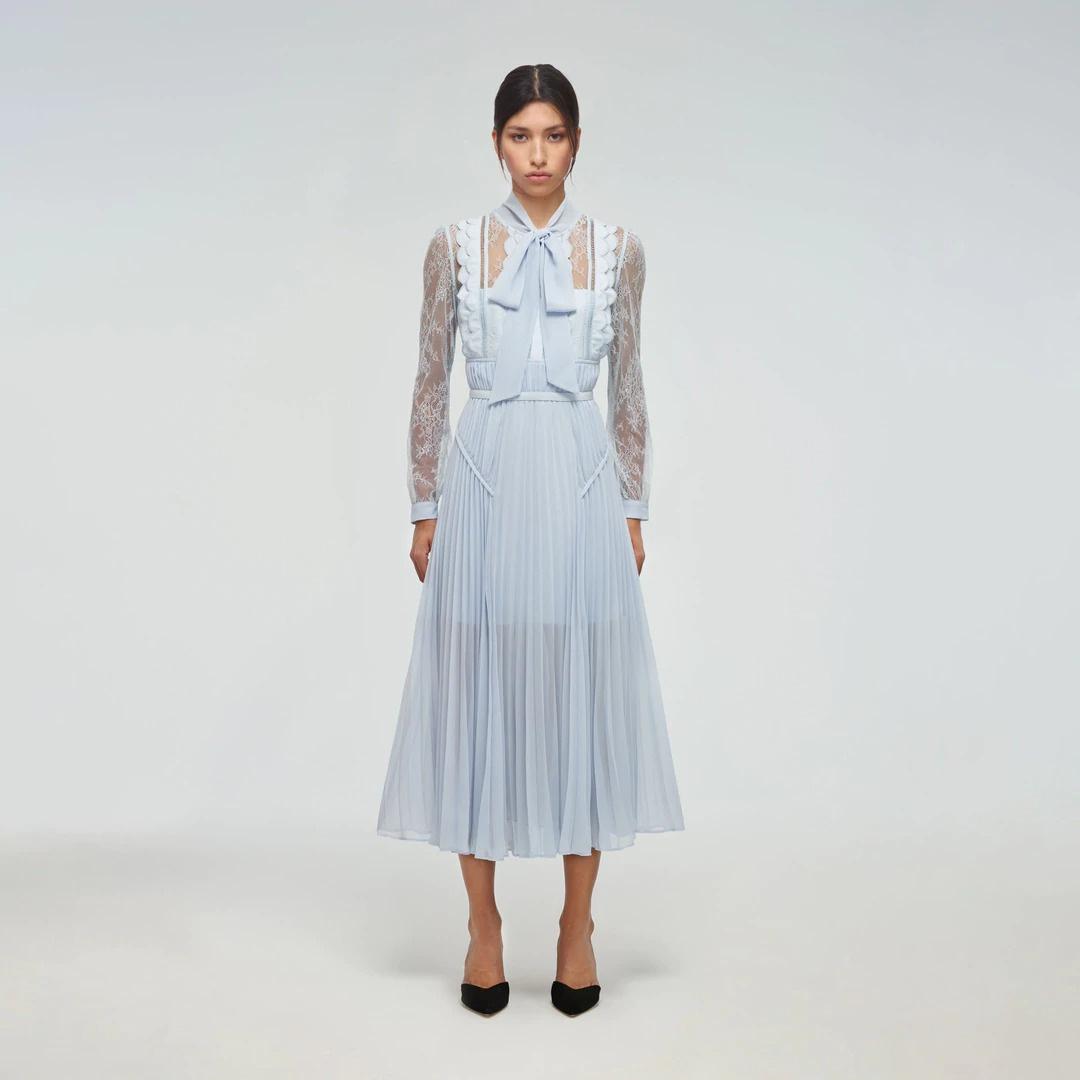 Model wearing a lace blue midi alice in wonderland wedding dress