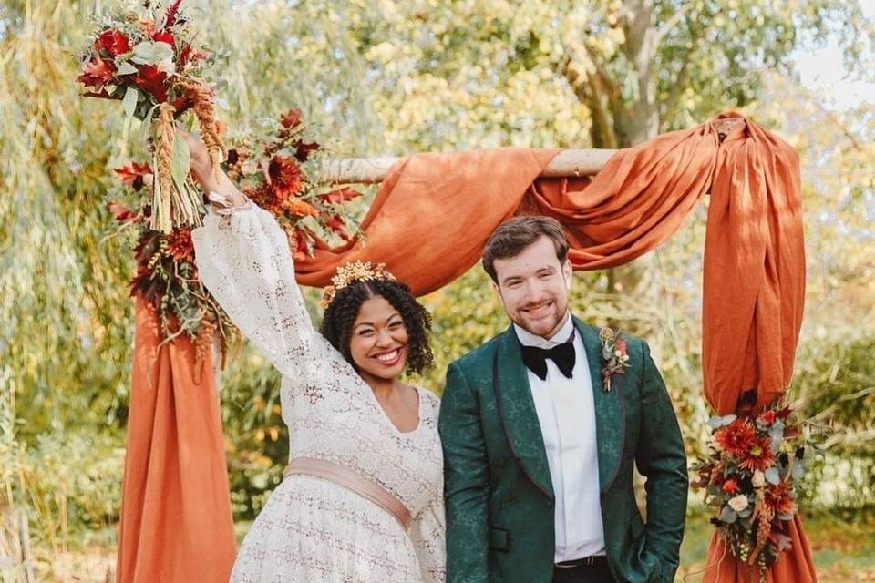 Happy couple at autumn themed wedding