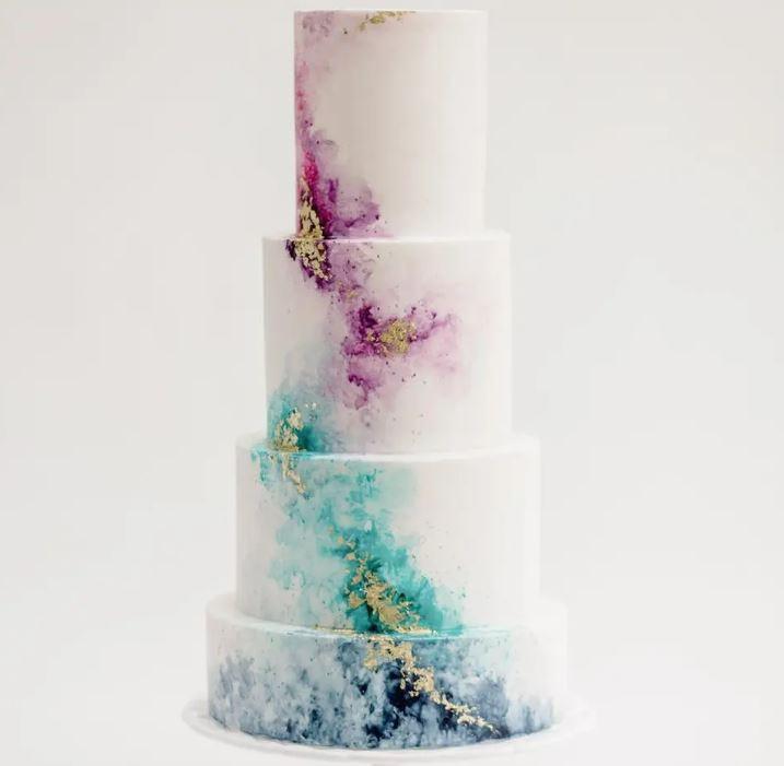 watercolour wedding cake in white and pastel colours with gold leaf accents