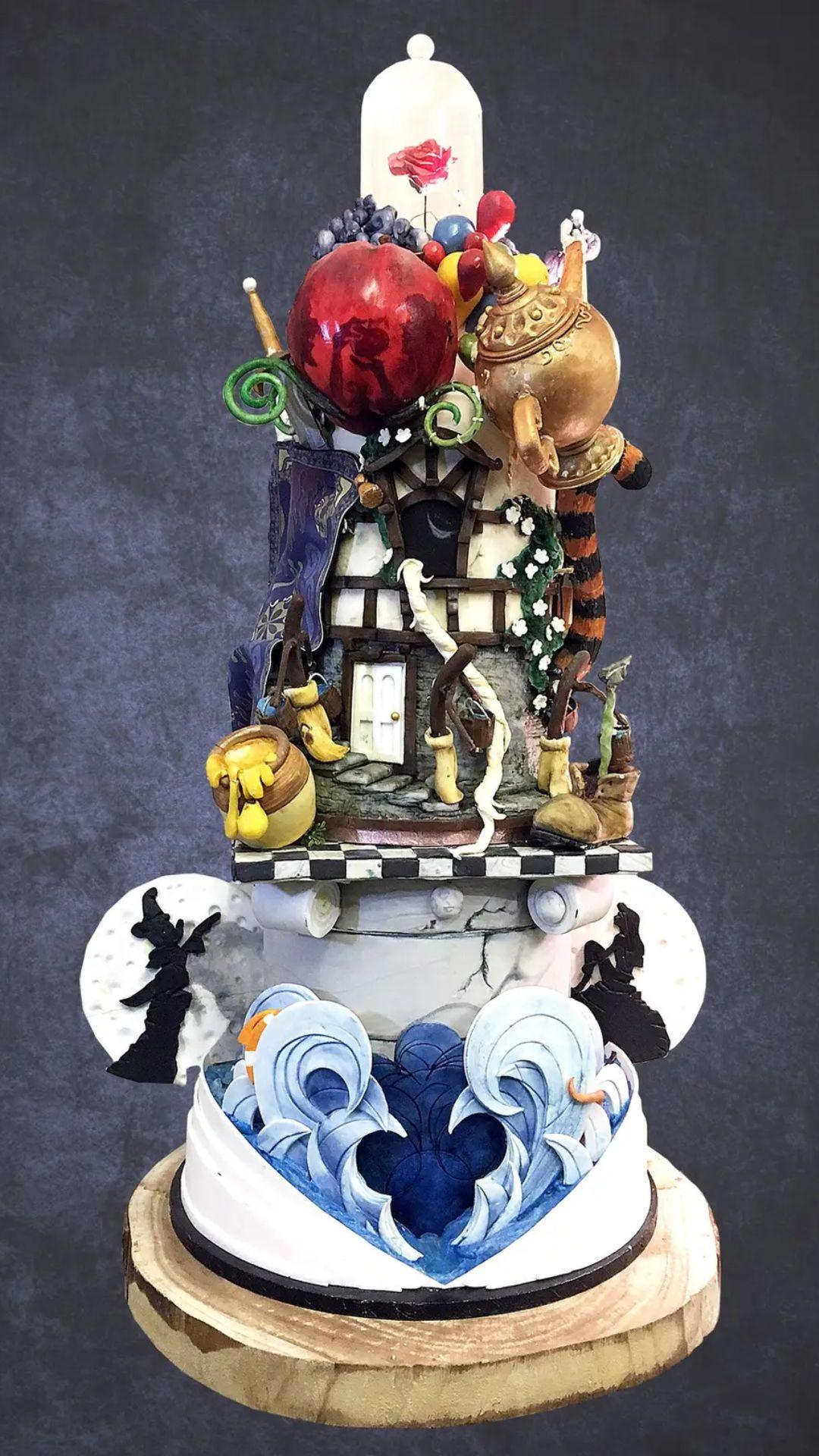 Disney wedding cake with a range of Disney characters and props on it