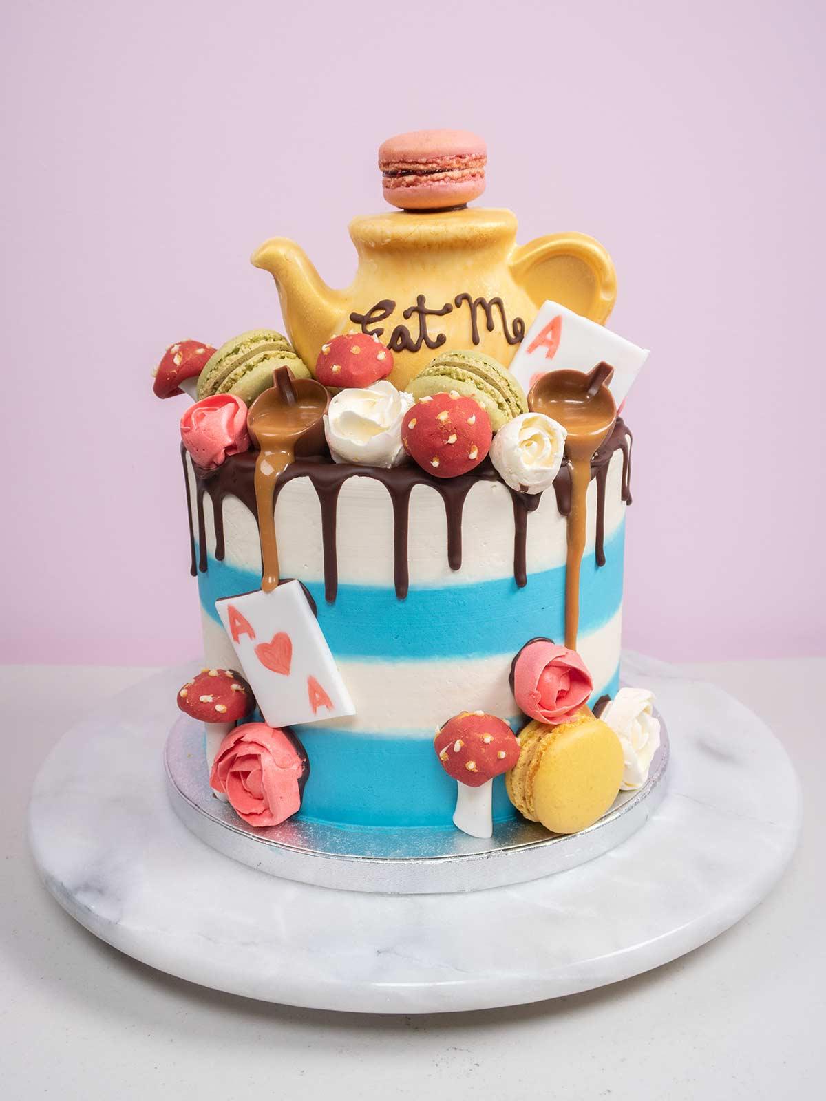 Alice in Wonderland wedding cake with mushrooms, tea pot and playing cards