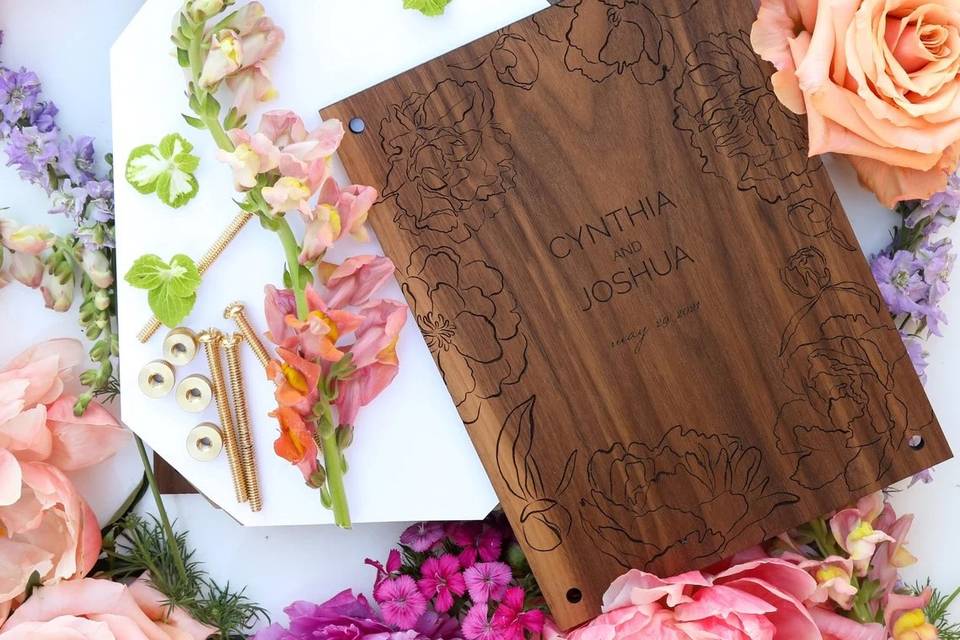 Wooden wedding flower press surrounded by bright blooms