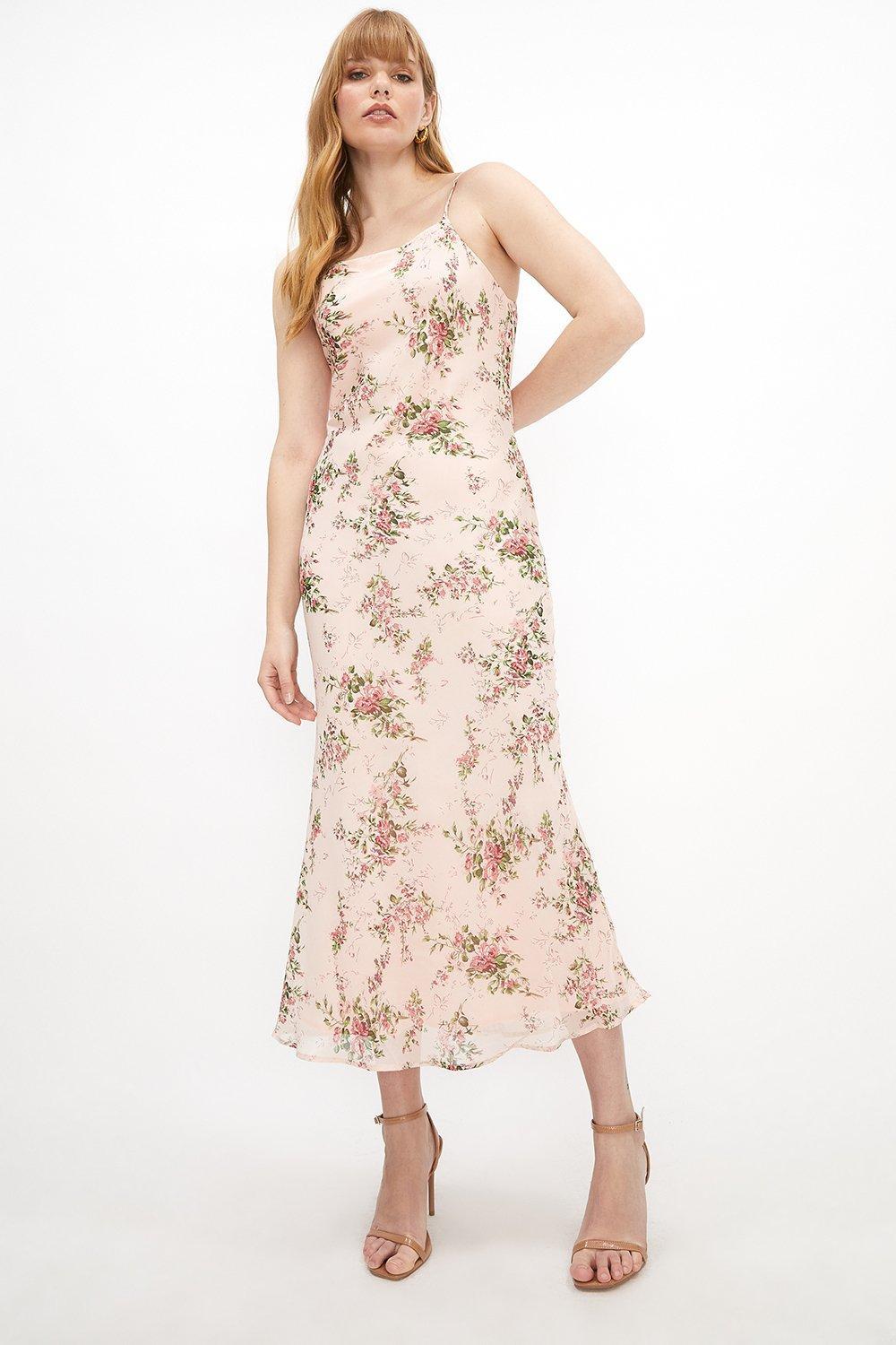 Model wearing a pink floral slip bridesmaid dress