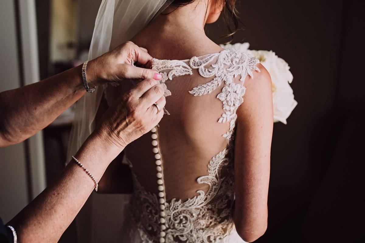 Bride trying on her wedding dress