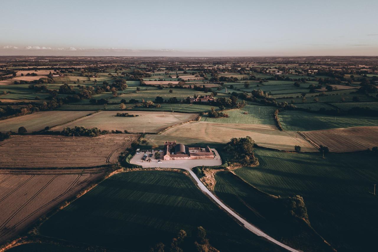 Birds eye view of Grangefields barn wedding venue surrounded by countryside