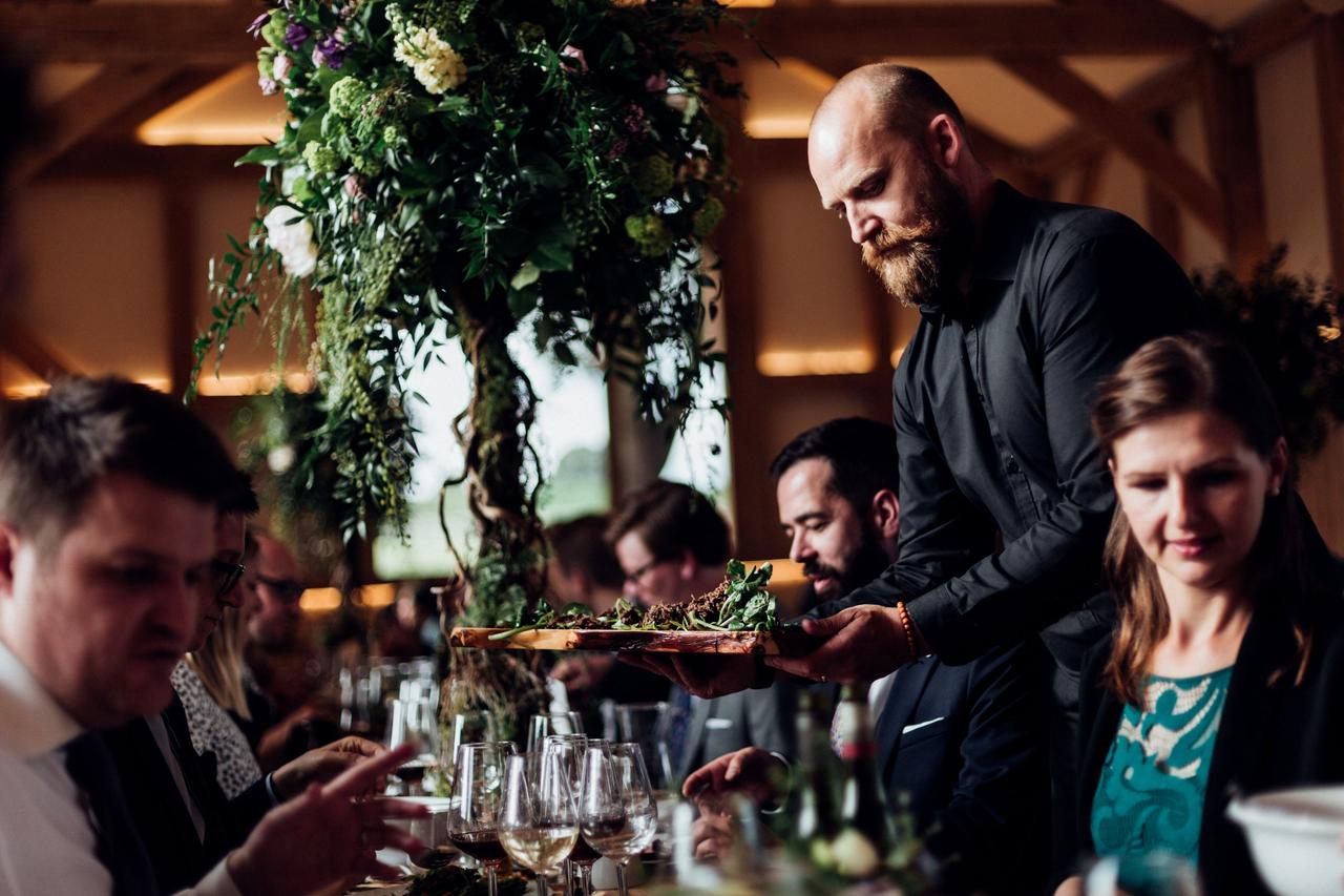 Marc Hornby serving guests at a wedding catered by Caviar & Chips
