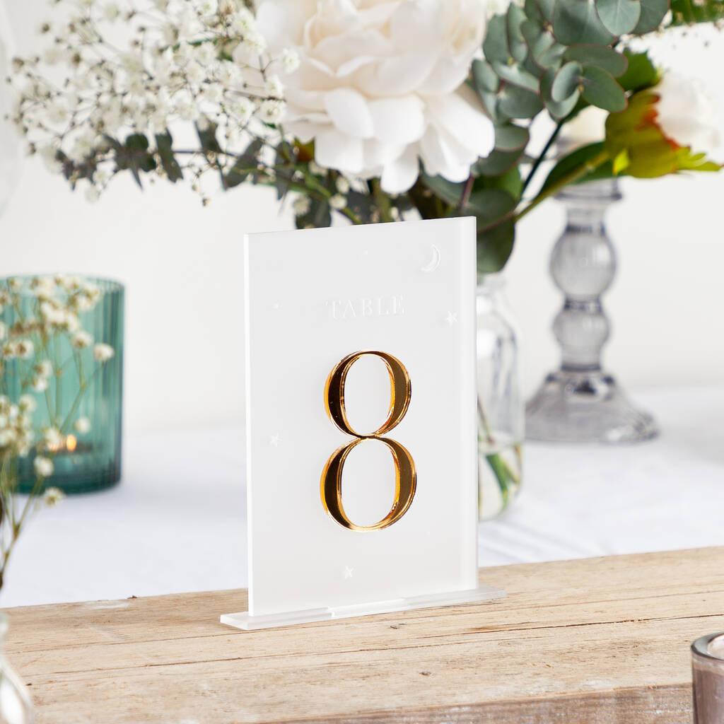 white acrylic table number with gold embossed number 8 and starry detail