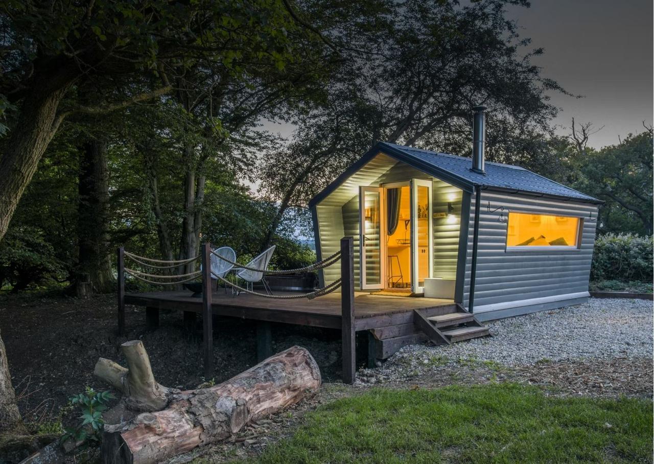 Tin cabin in the forest with hot tub and wood burning fire