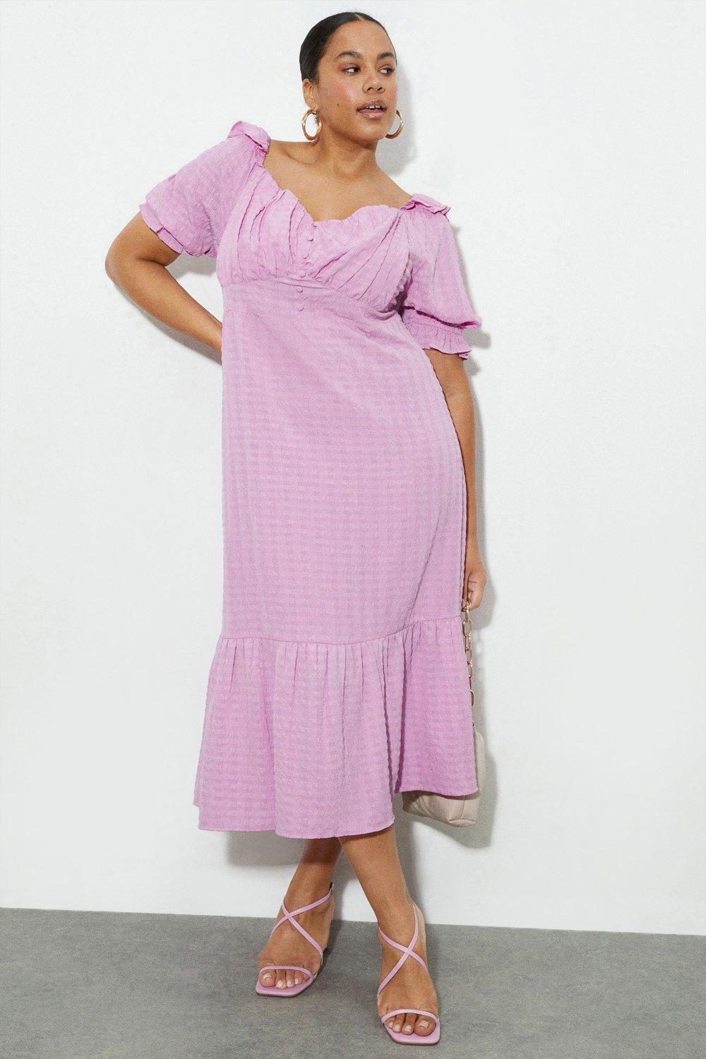 Model wearing a lilac puff sleeve midi wedding guest dress