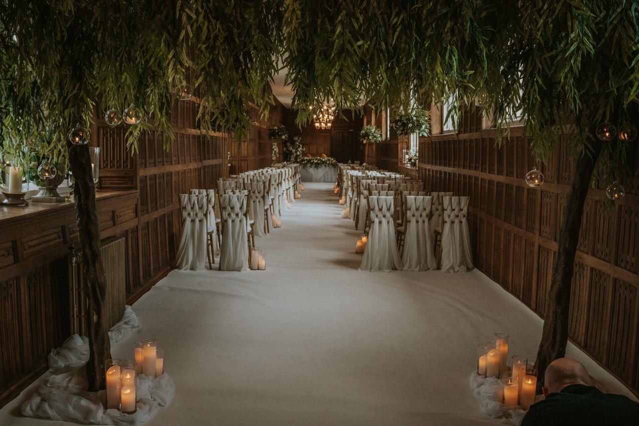 Wedding aisle decorated with green trees