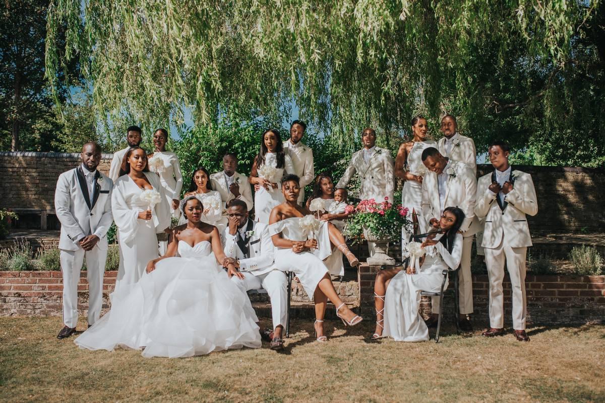 Wedding guests gather under a tree