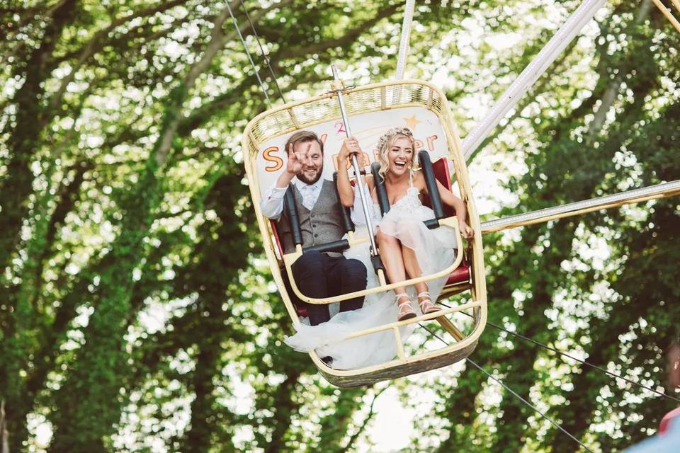 married couple having fun on an unusual wedding entertainment ride