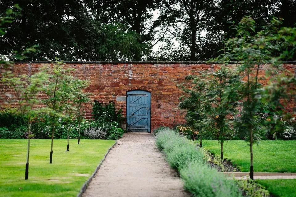 Blue door in a stone walled garden