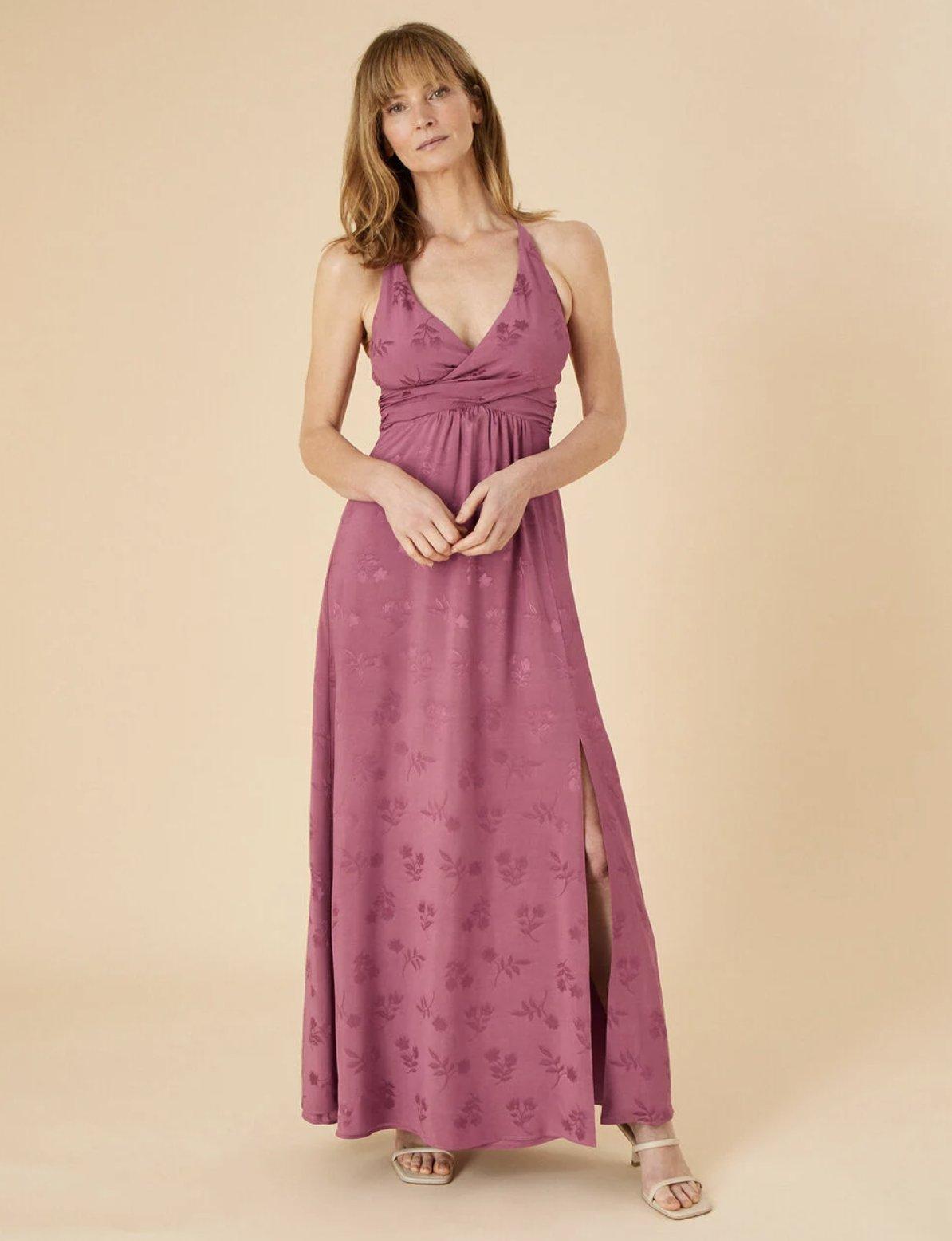 Image of a model wearing a satin jaquard maxi dress in pink with a wrapped waist
