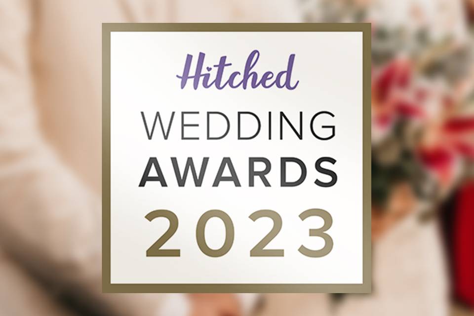 Hitched Wedding Awaards 2023 brand logo with wedding image blurred in the background