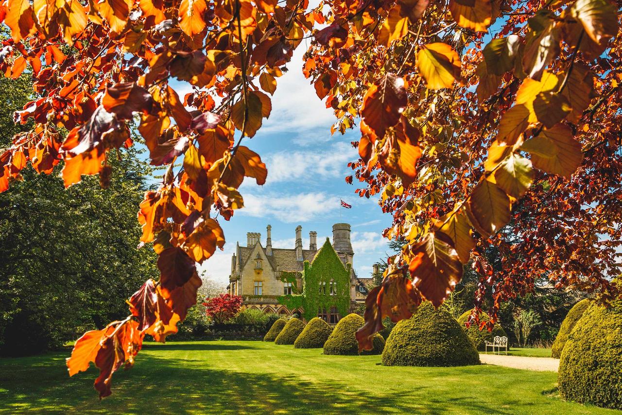 Historic wedding venue framed by autumn leaves