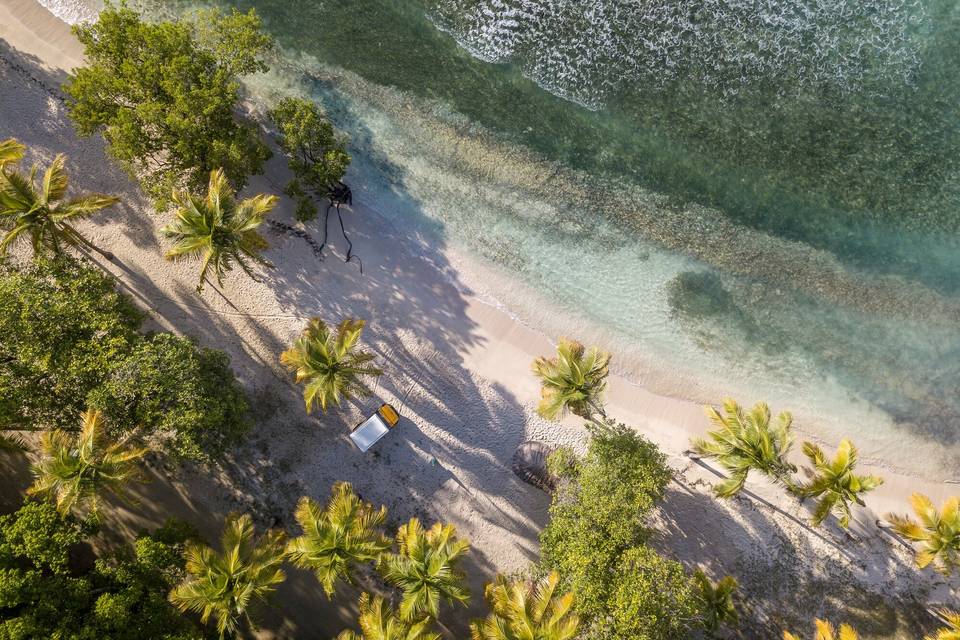 A bird's eye view of the beach on the island of Mustique, white sands and clear blue seas