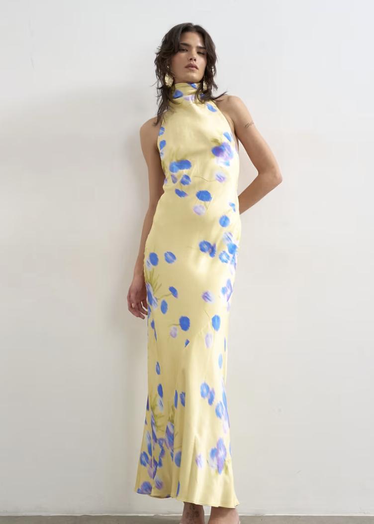 yellow satin halterneck wedding guest dress with blue flowers