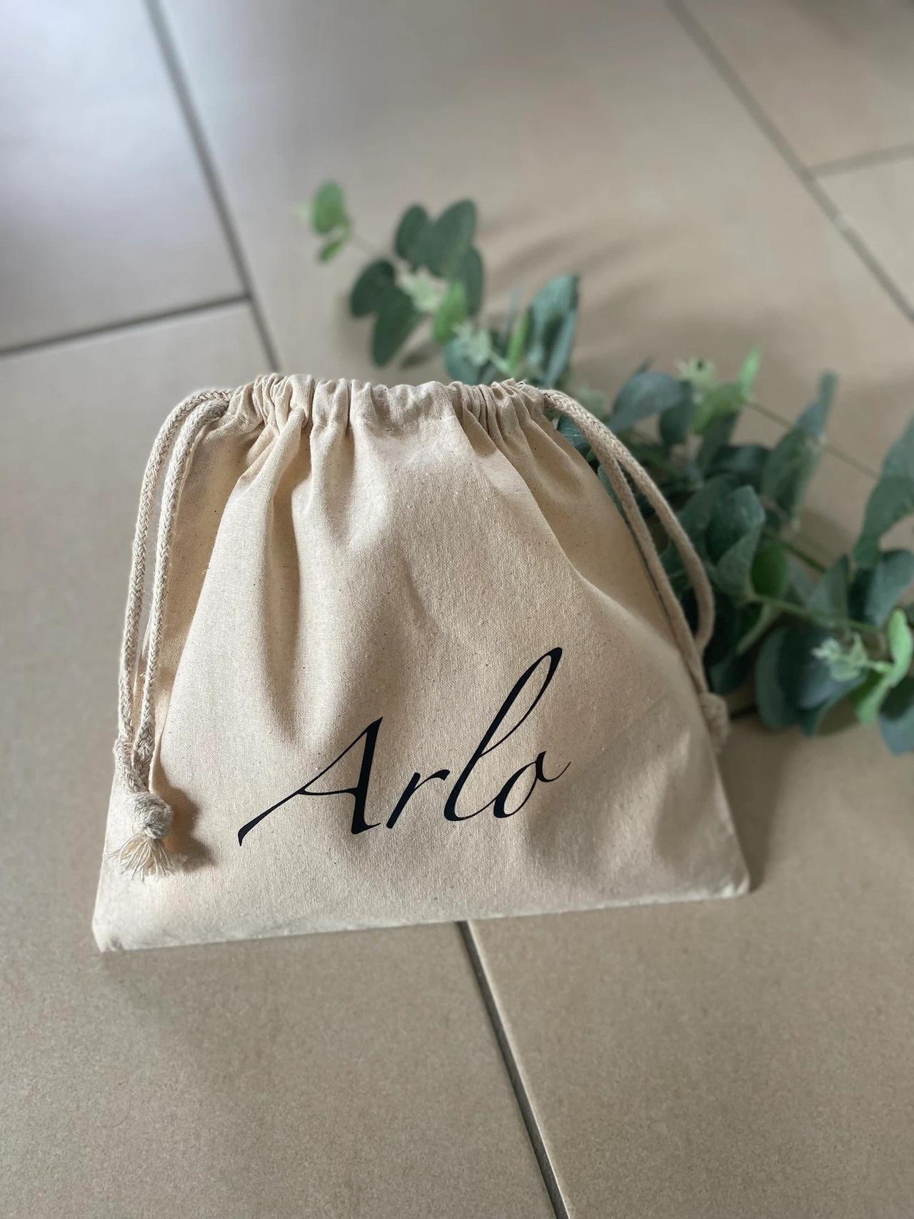little drawstring bag with arlo written on it