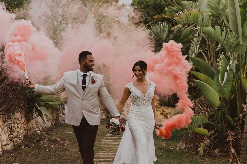 Bride and groom with a pink smoke stick