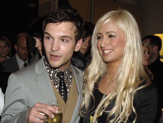 Chantelle Houghton smiling with her arm around Preston at an event as he holds a glass of white wine