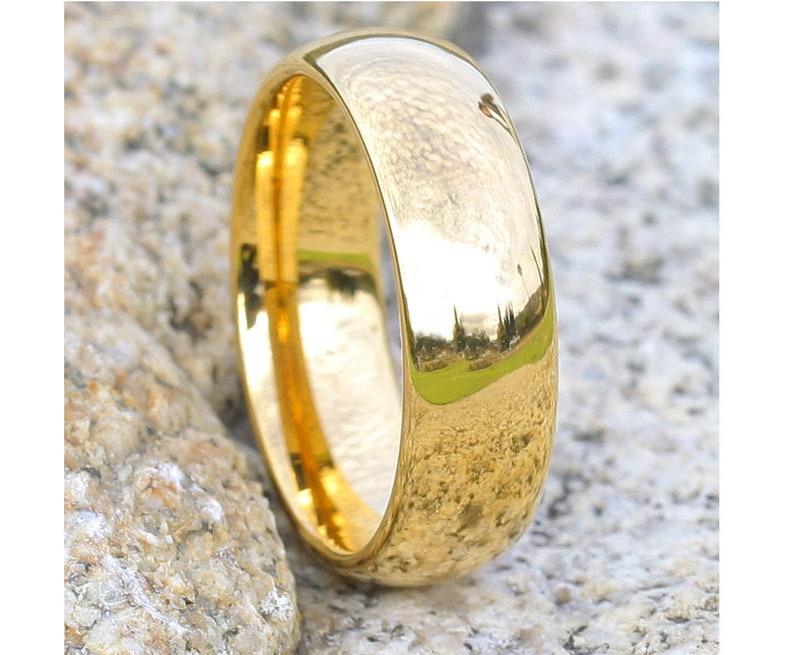Wide, shiny yellow gold wedding band
