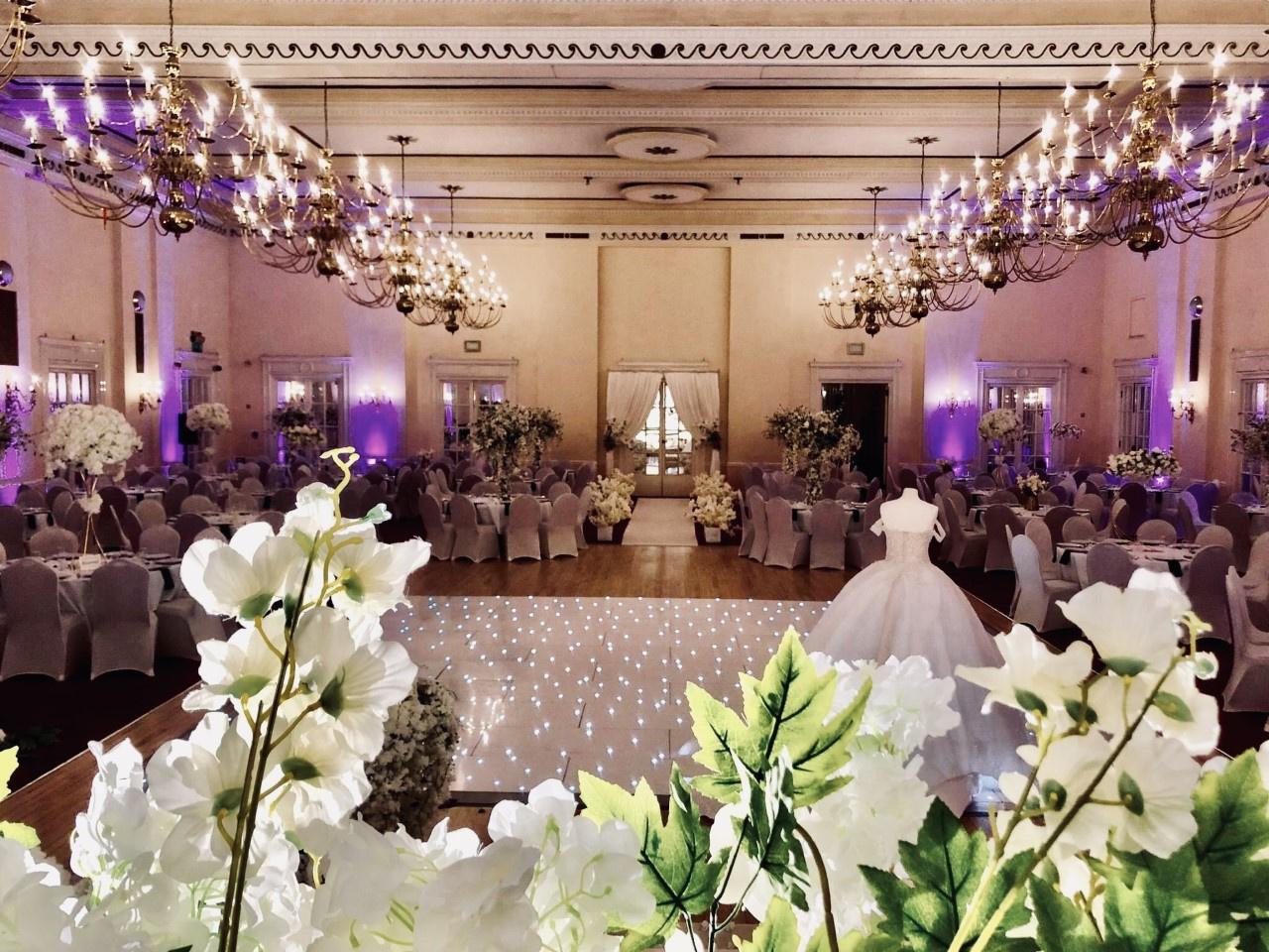 the redeption room at the adelphi hotel with white dance floor, a wedding dress and tables surrounding it