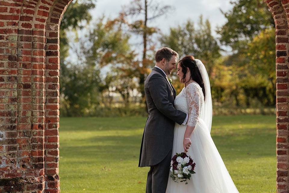 Ben and Becky from the side in a red brick archway