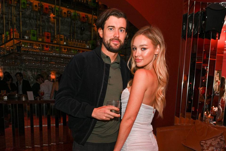 Jack Whitehall and his girlfriend Roxy Horner dressed up being photographed at an event
