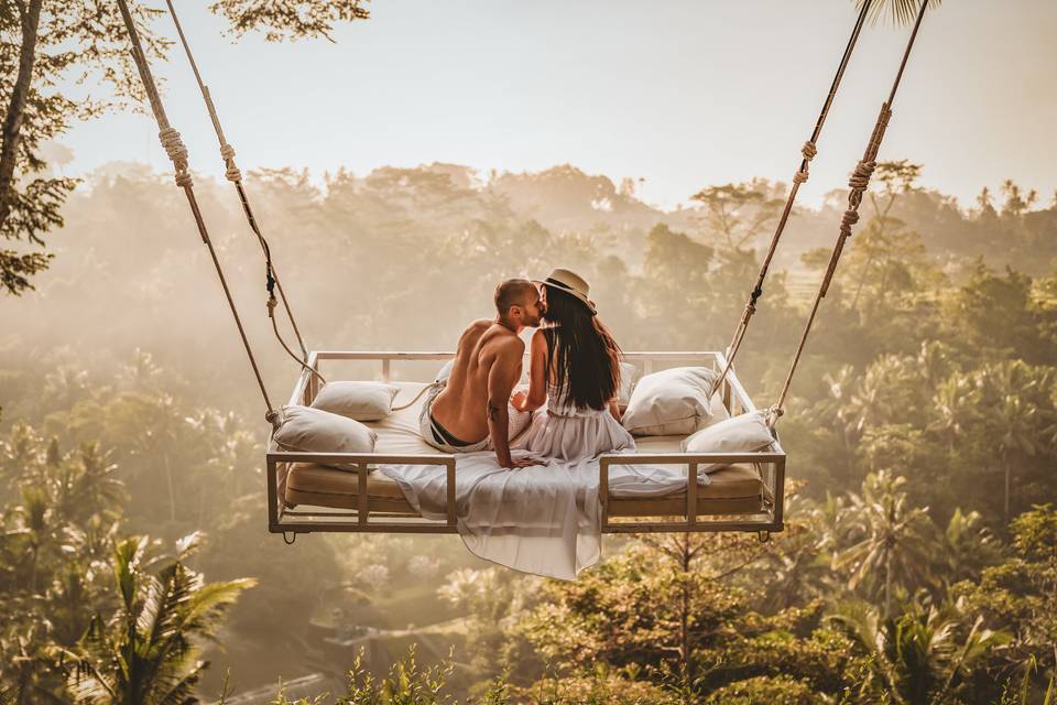 Couple kissing on a swing in Bali