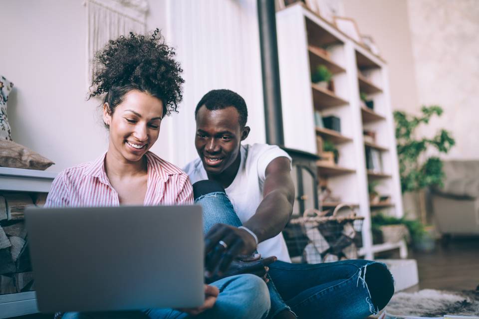 Young couple on laptop planning wedding