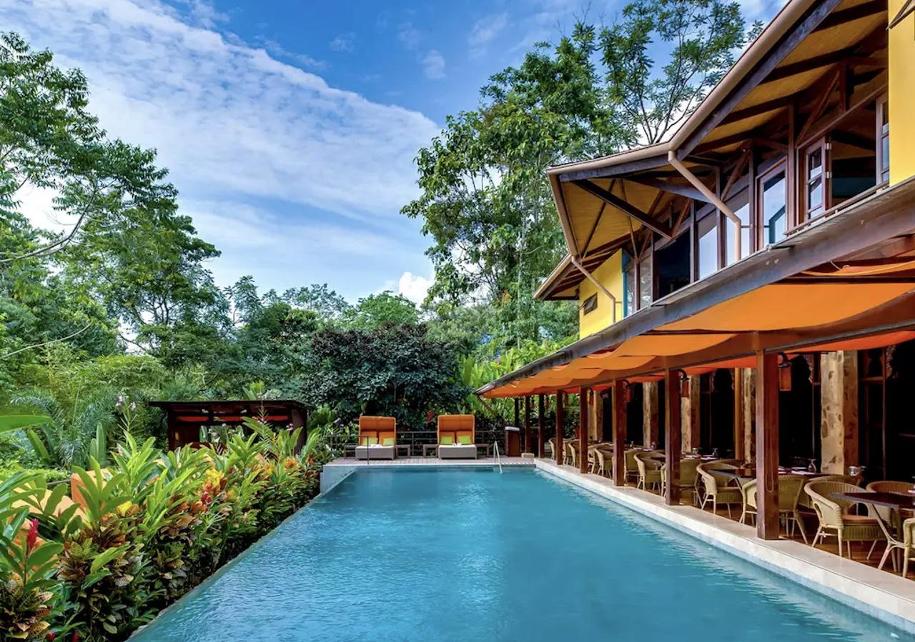 A South American house in front of a luxurious pool in a rainforest at Nayara Springs in Costa Rica
