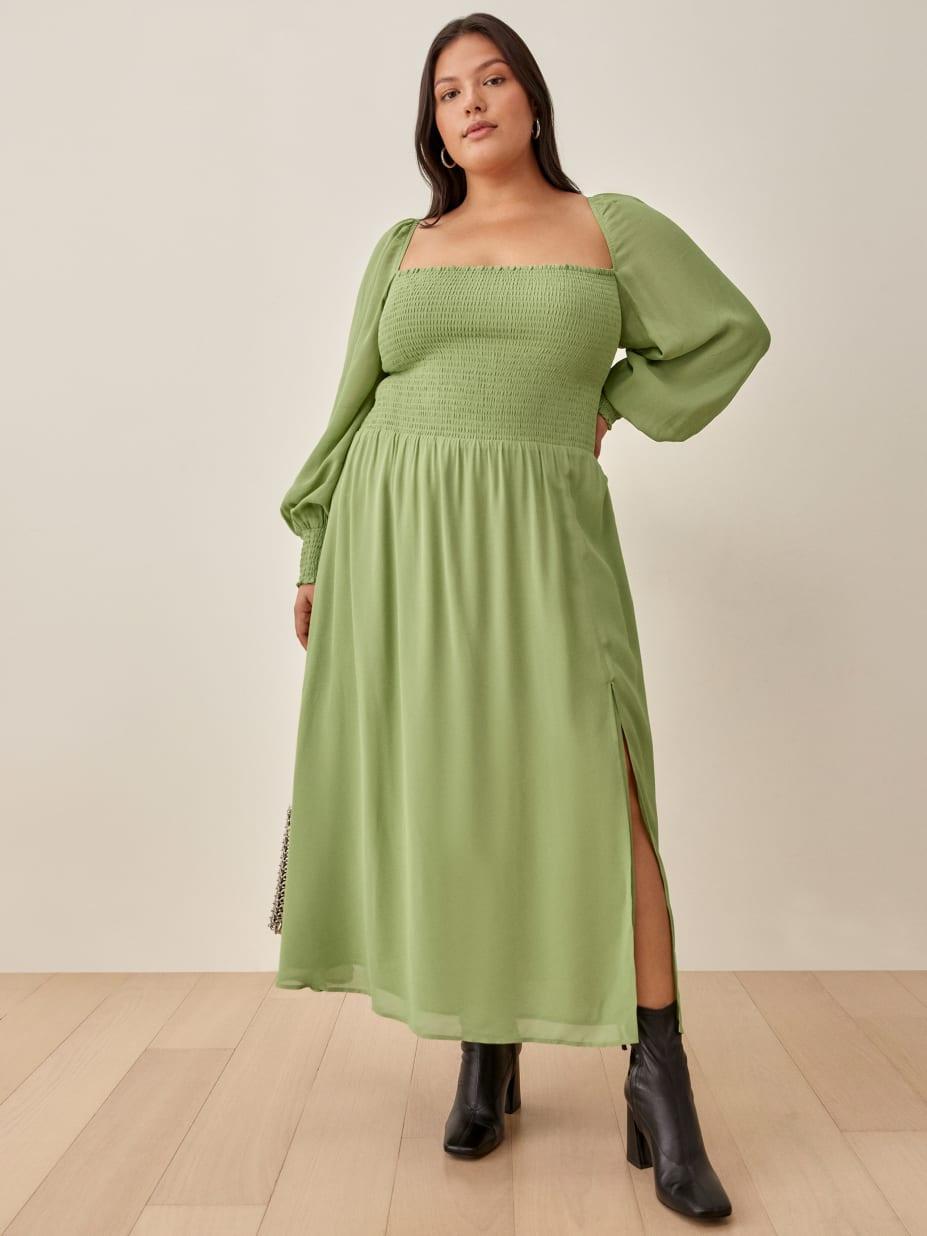 Model wearing a Cello dress, with form-fitting smocked bodice and relaxed-fit skirt in green