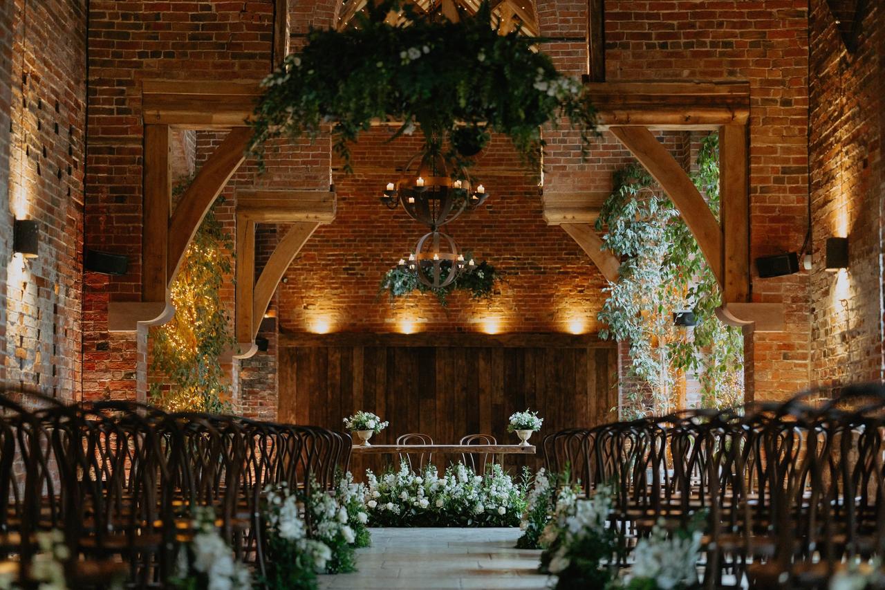 Rustic wedding ceremony space inside a brick barn