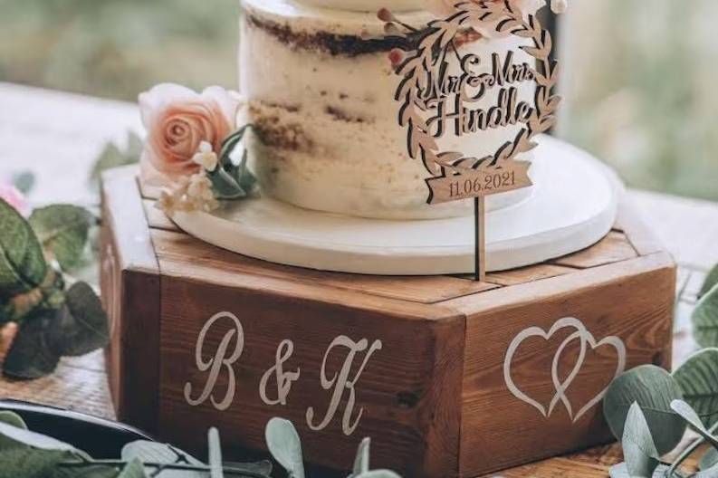 Semi naked wedding cake on a personalised wooden hexagon wedding cake stand
