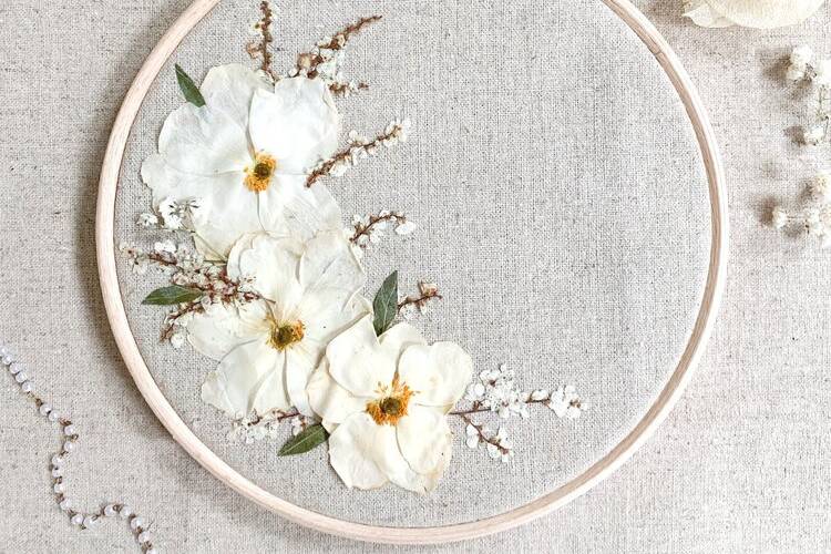 Embroidery hoop with white floral decorations