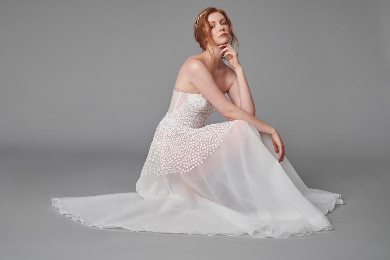 Image of a model wearing a unique sheer wedding dress with polka-dot details