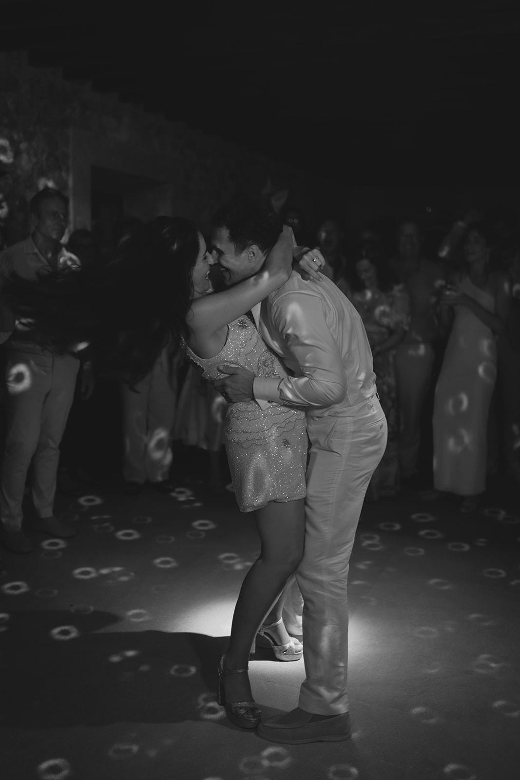 Josie & Cameron smiling and laughing together on the dancefloor