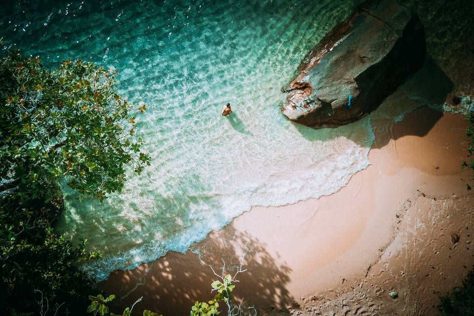 a person in the waters swimming on honeymoon in april in fiji approaching a sandy beach