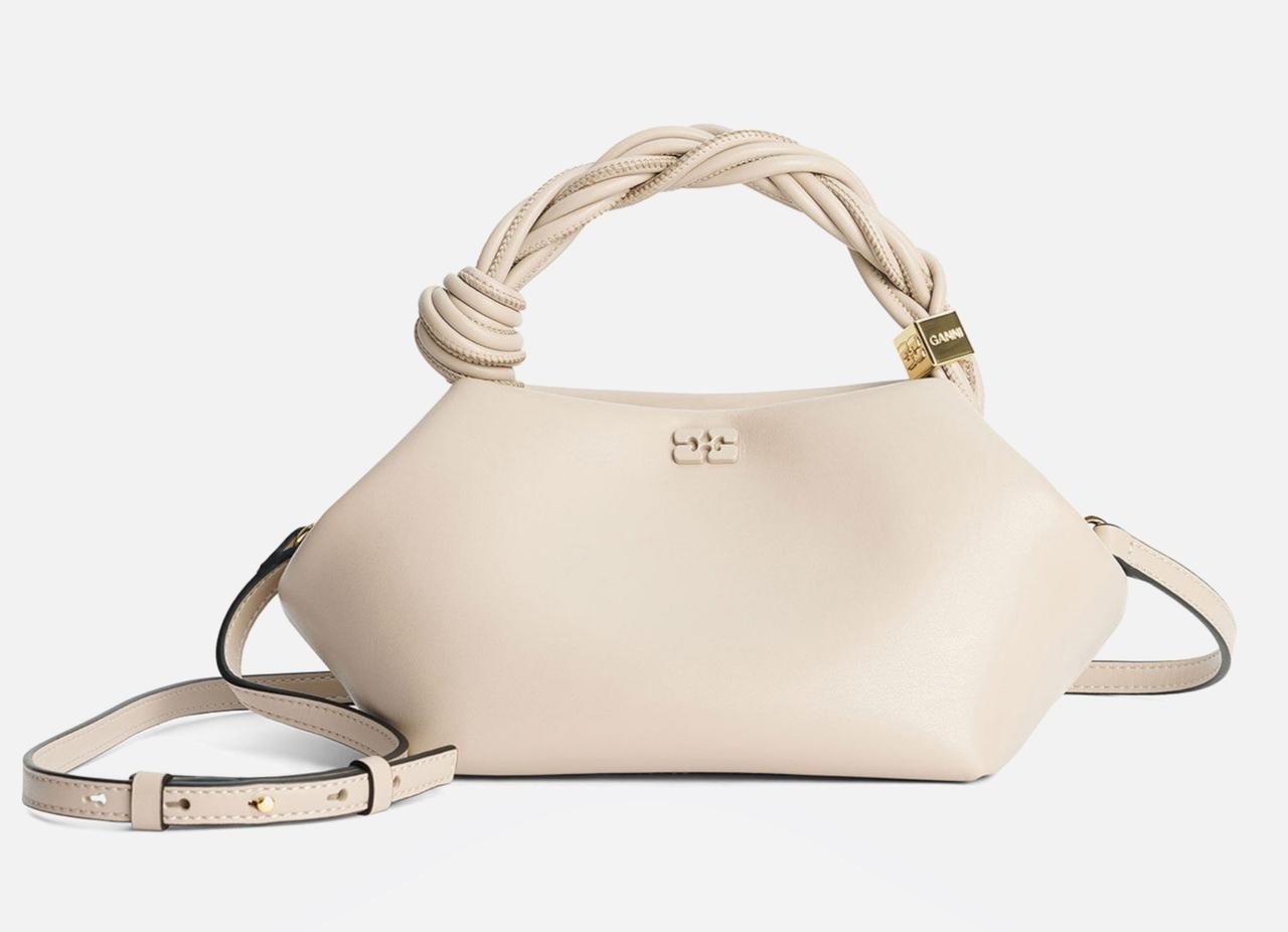 An oyster grey coloured handbag with twisted handle detail and a crossbody strap.