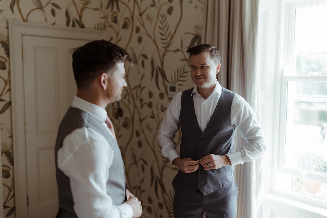 The grooms get dressed for the ceremony together