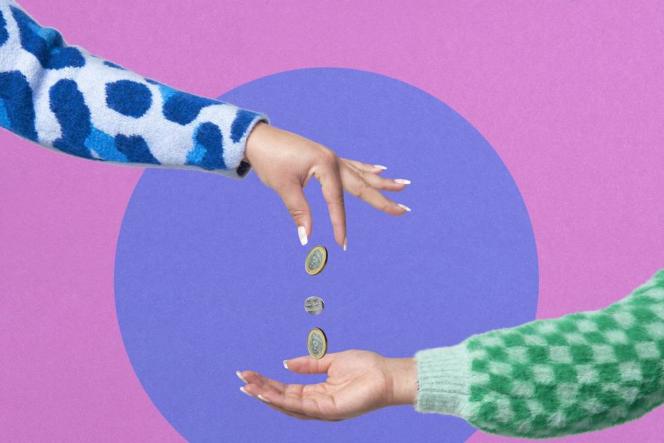 One hand dropping money into another outstretched hand in front of a colourful background