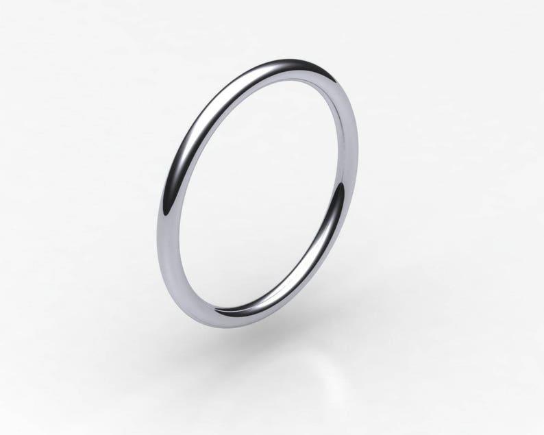 A narrow platinum wedding band with smooth edges