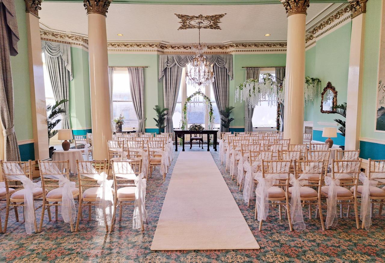 Interior of a ceremony room at a hotel wedding venue with vintage decor.