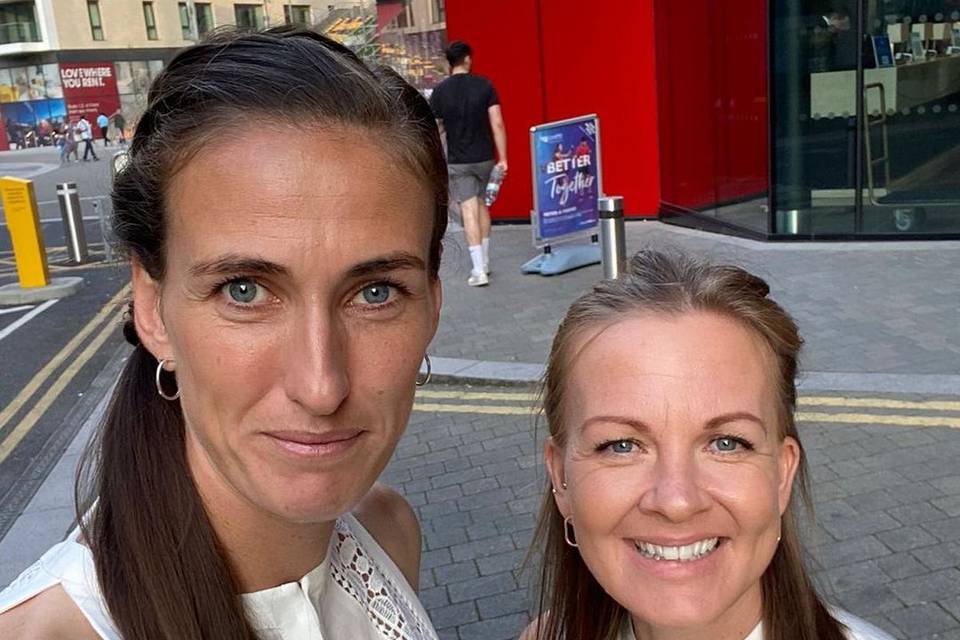 Shelly Unitt and Jill Scott posing for a selfie in matching white tops 