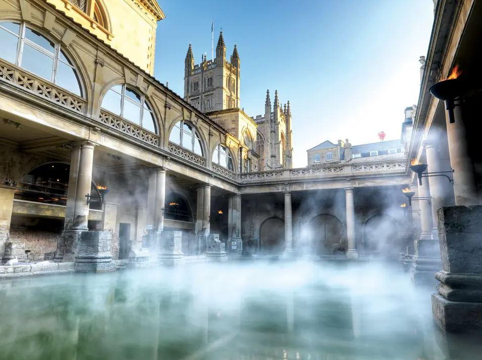 a view of steam rising with the historic roman baths in the city centre of Bath